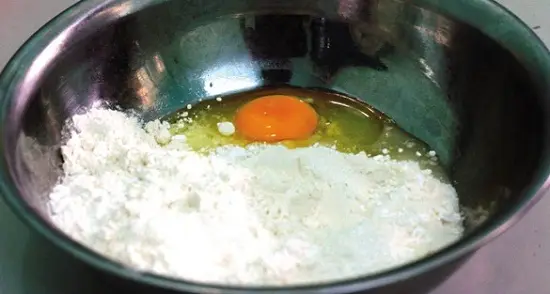 Cho bột mỳ và trứng vào để làm bánh tôm chiên